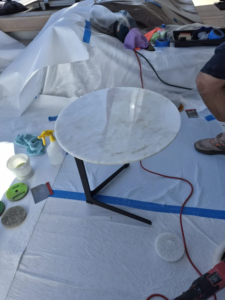 Marble table being polished on board