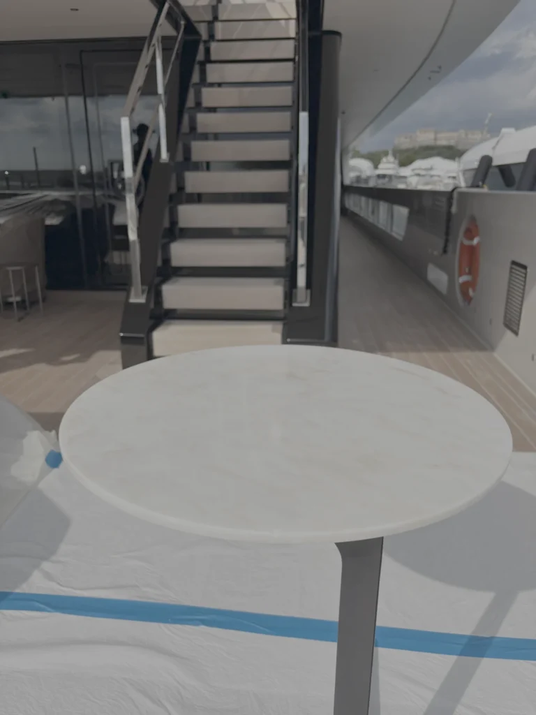 Round marble table on deck, surrounding areas protected