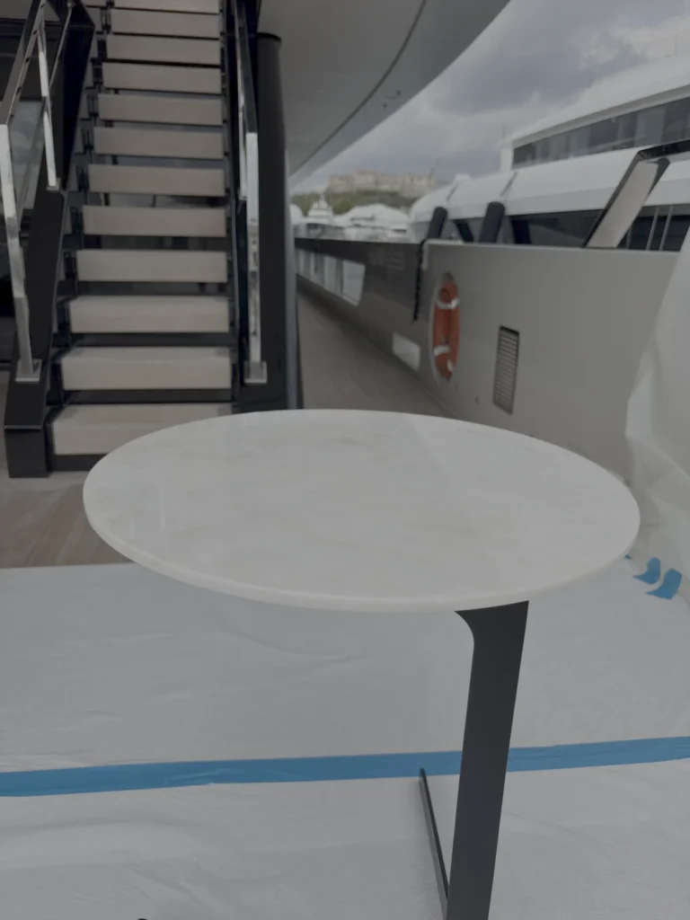 Round marble table top during polishing on deck